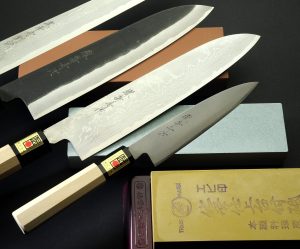 plusieurs couteaux japonais posés sur des pierres à eau